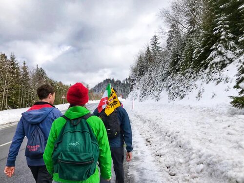 Des marcheurs sous la neige arrivent à la Vue des Alpes